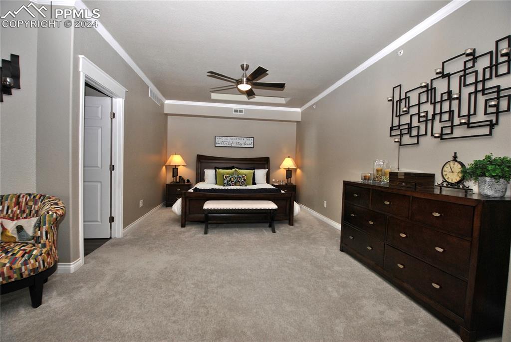 3770 Presidio Point, Unit 201 Colorado Springs, CO 80920 - Photo 26 of 40 a bedroom with furniture and a chandelier