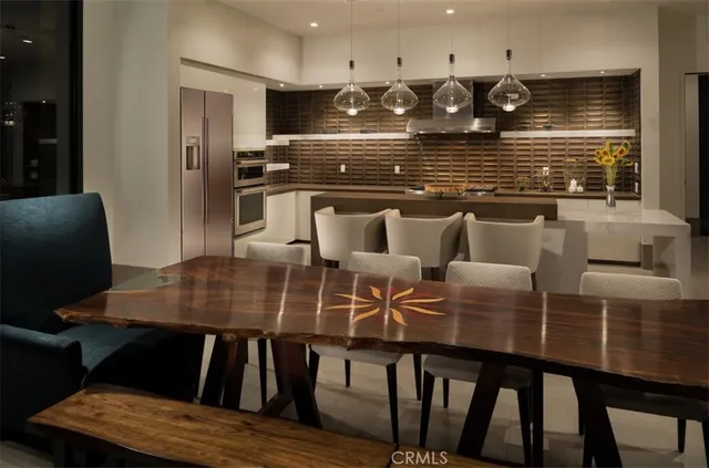 a kitchen with a table chairs and a refrigerator