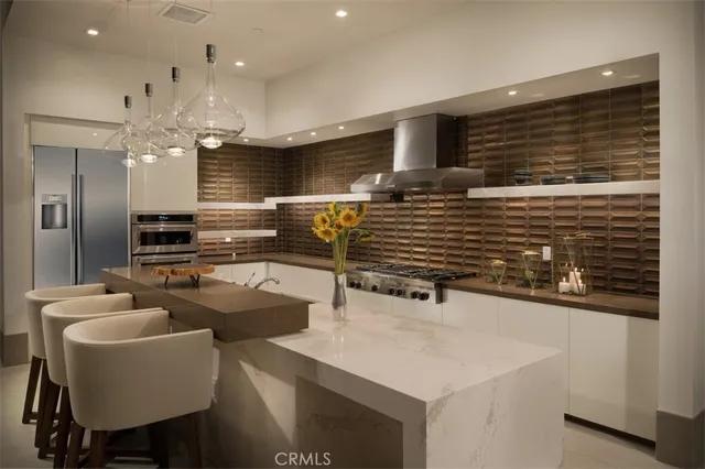 a kitchen with stainless steel appliances granite countertop a sink and a refrigerator
