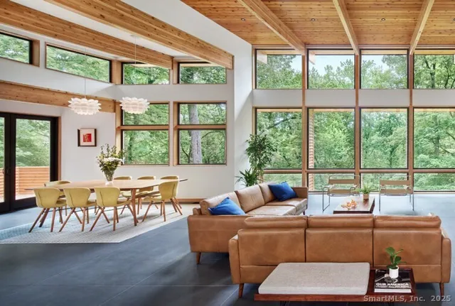 a living room with furniture and large windows