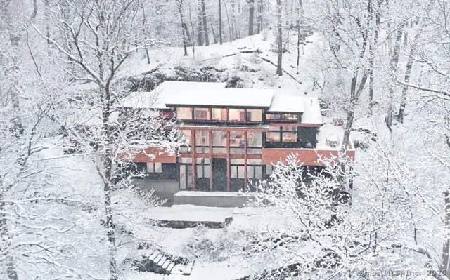 a view of a house with a yard covered with snow