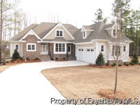 Lot 279 Falling Water Road Spring Lake, NC 28390 - Photo 2 of 12 a front view of a house with a yard and garage