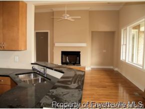 Lot 279 Falling Water Road Spring Lake, NC 28390 - Photo 4 of 12 a kitchen with a sink and a fireplace