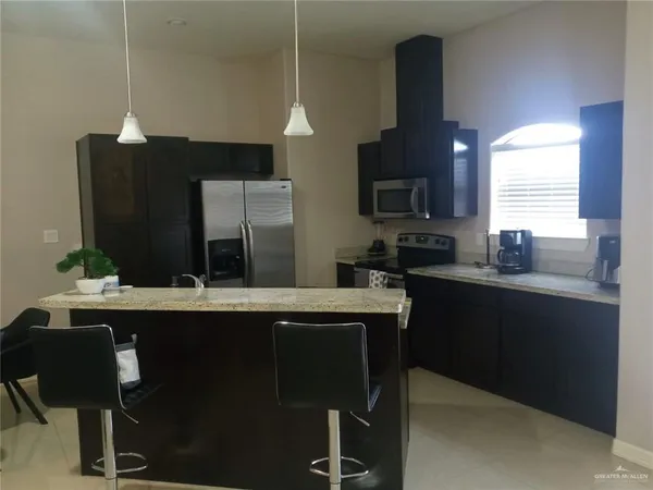 a kitchen with a sink cabinets and window