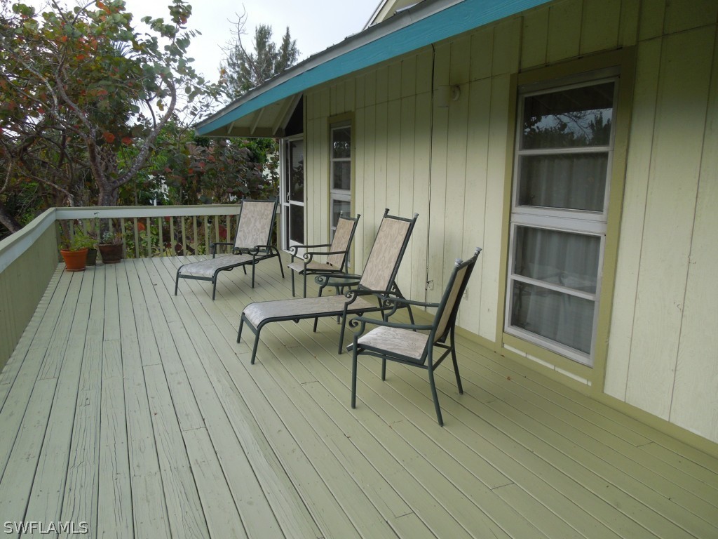 828 Rabbit Road Sanibel, FL 33957 - Photo 6 of 15 a view of a chairs and table on the deck