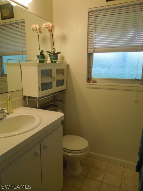 828 Rabbit Road Sanibel, FL 33957 - Photo 8 of 15 a bathroom with a sink a toilet and mirror