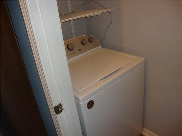 a close up of a storage and utility room with washer and dryer