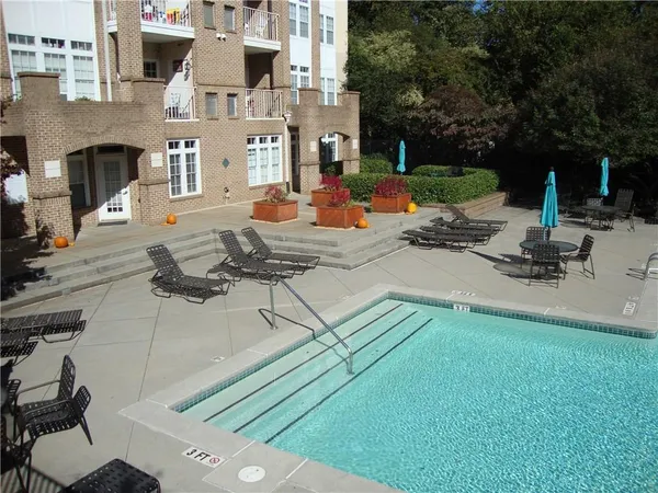 a view of a patio with couches and a fireplace