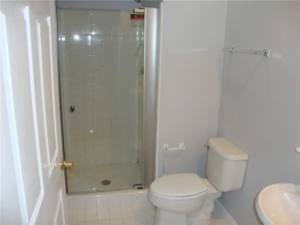 a bathroom with a toilet and a shower