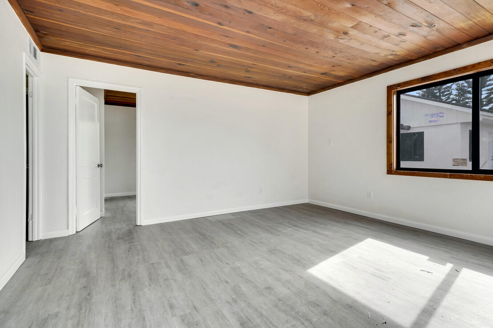 652 Hernando Street, Unit C Fort Pierce, FL 34949 - Photo 2 of 18 an empty room with wooden floor and windows