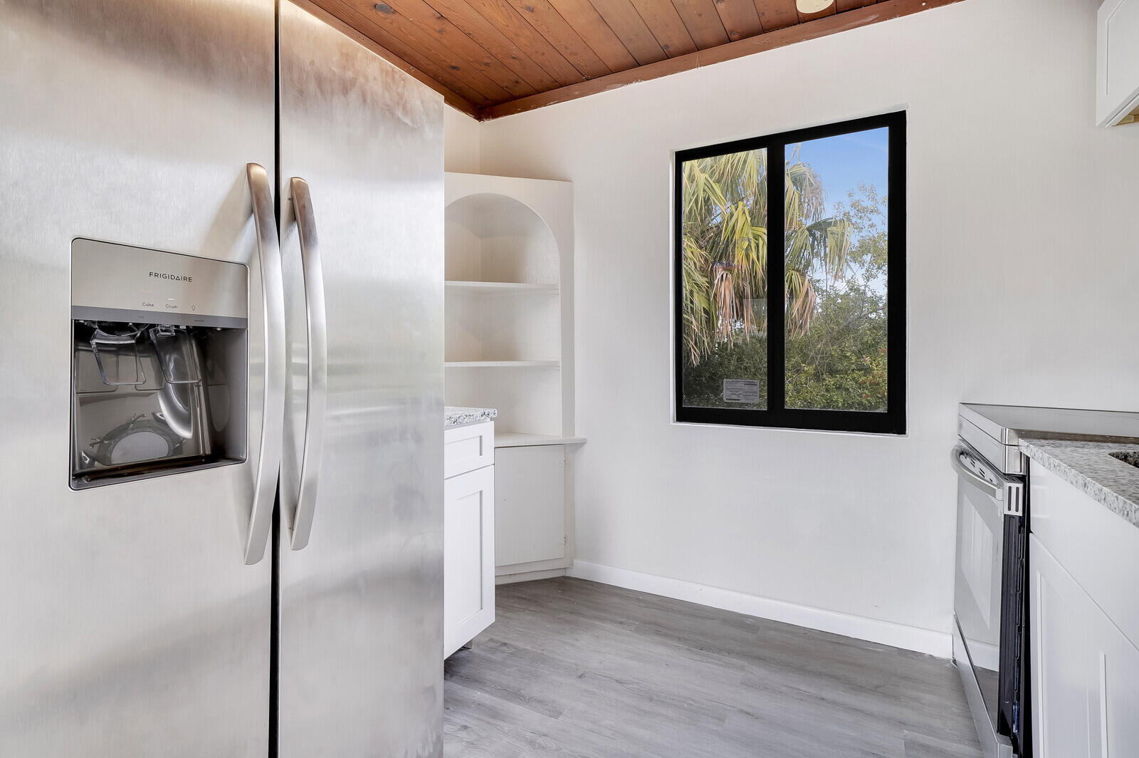 652 Hernando Street, Unit C Fort Pierce, FL 34949 - Photo 6 of 18 an empty room with wooden floor and windows