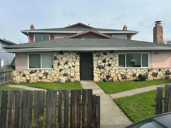 a front view of a house with a garden