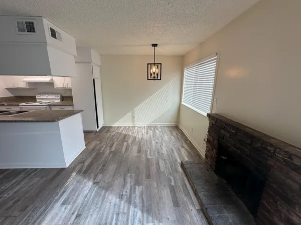 a kitchen with wooden floors and appliances