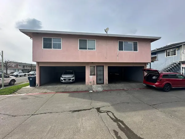 a front view of a house with parking space