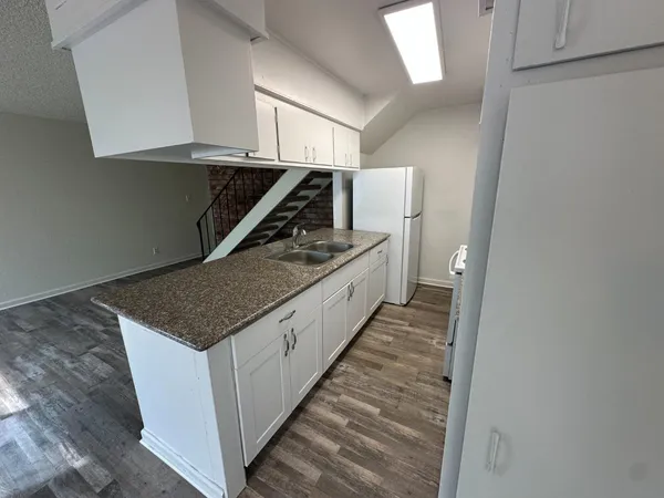 a kitchen with a stove and a refrigerator