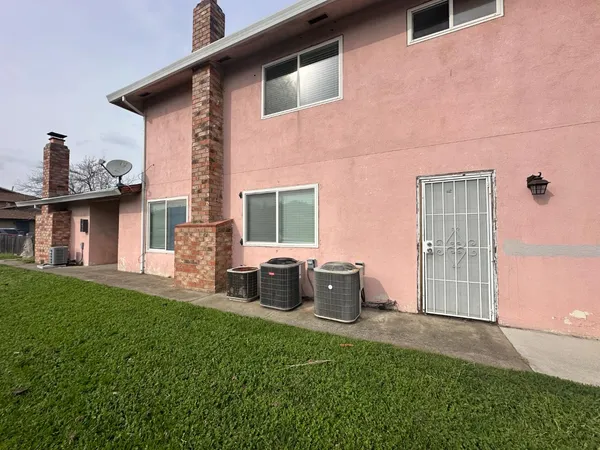 a backyard of a house with table and chairs