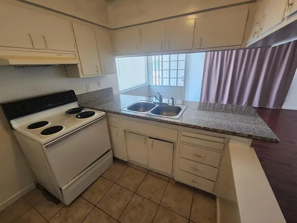 a bathroom with a granite countertop sink and cabinets
