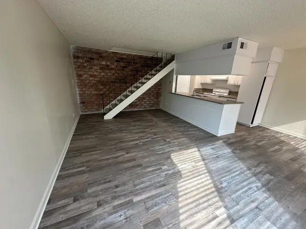 a view of kitchen and wooden floor