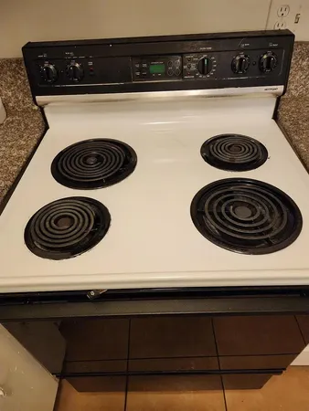 a close view of stove a microwave and stove