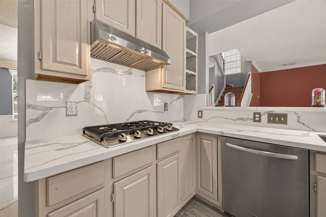 a kitchen with cabinets and appliances