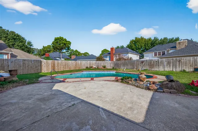 a view of a swimming pool with a yard