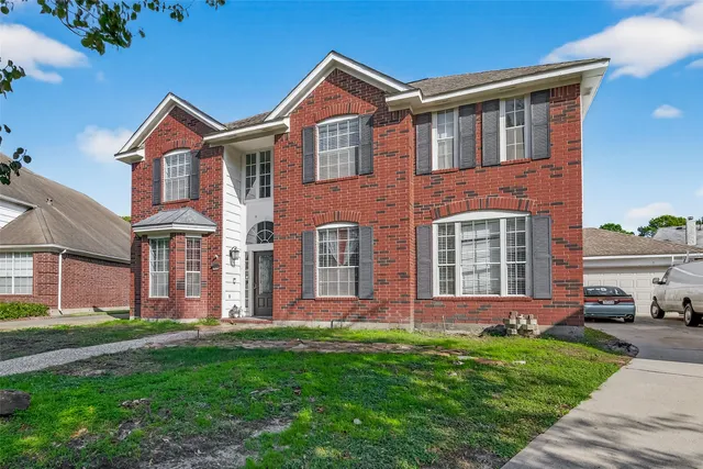 front view of brick house with a yard