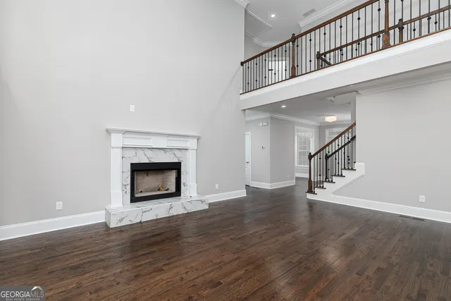 a view of kitchen with kitchen island wooden floor and electronic appliances