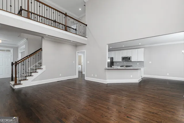 a view of a livingroom with wooden floor and windows