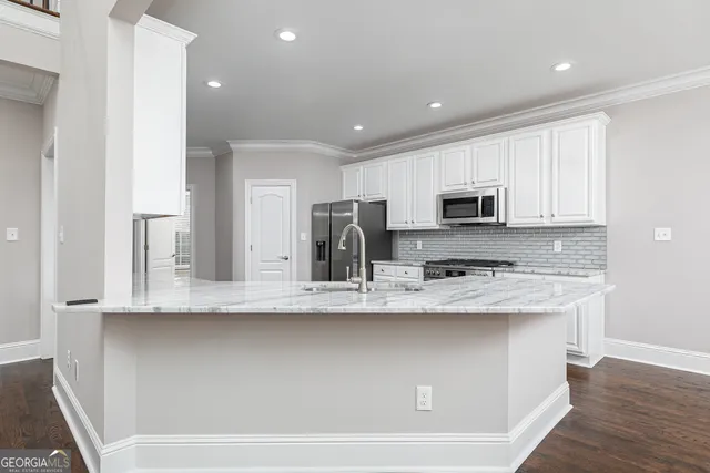 a kitchen with stainless steel appliances granite countertop a sink and a microwave