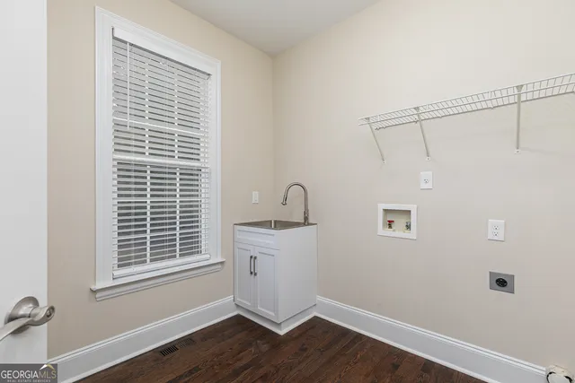 a view of an empty room with chandelier fan
