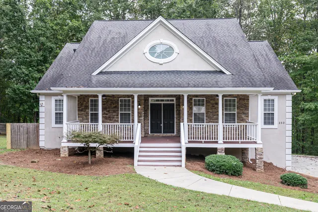 a front view of a house with garden and porch