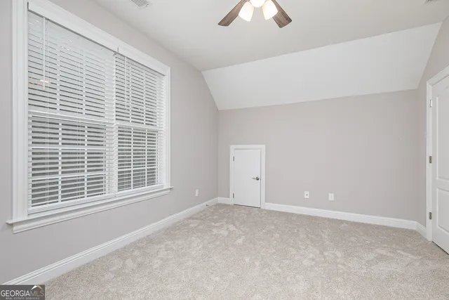 a bathroom with a granite countertop toilet a sink and a mirror