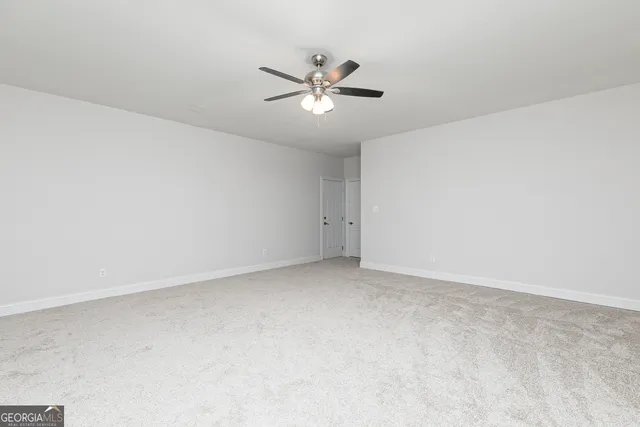 a view of a room with wooden floor and window