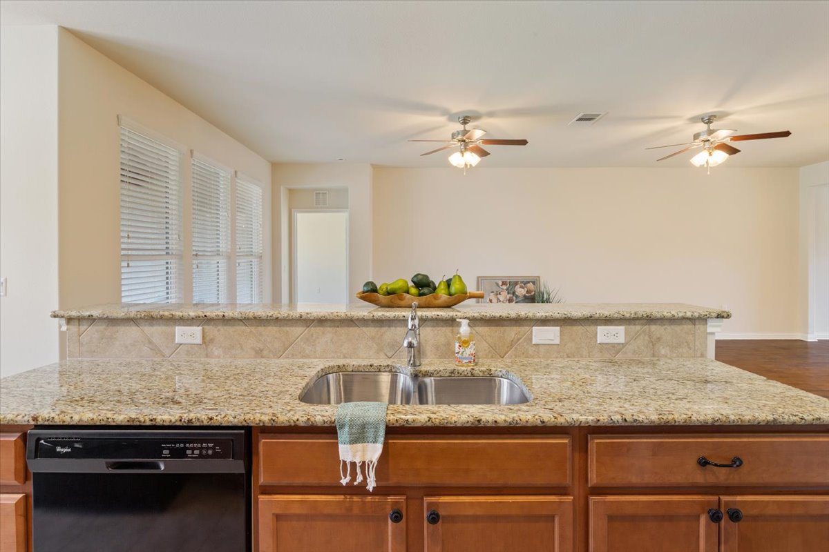 108 Cathedral Mountain Pass Georgetown, TX 78633 - Photo 15 of 36 a kitchen with granite countertop a counter space cabinets and stainless steel appliances