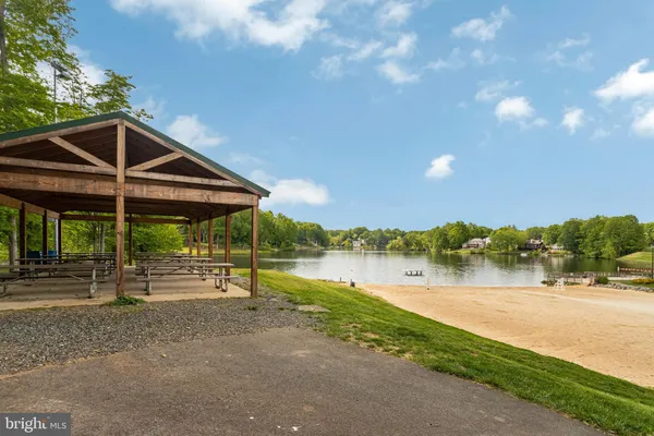 a view of lake with green space and mountain view in back