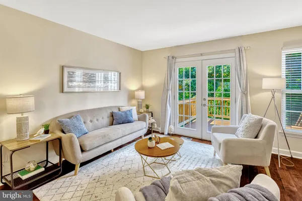 a living room with furniture a rug and a large window