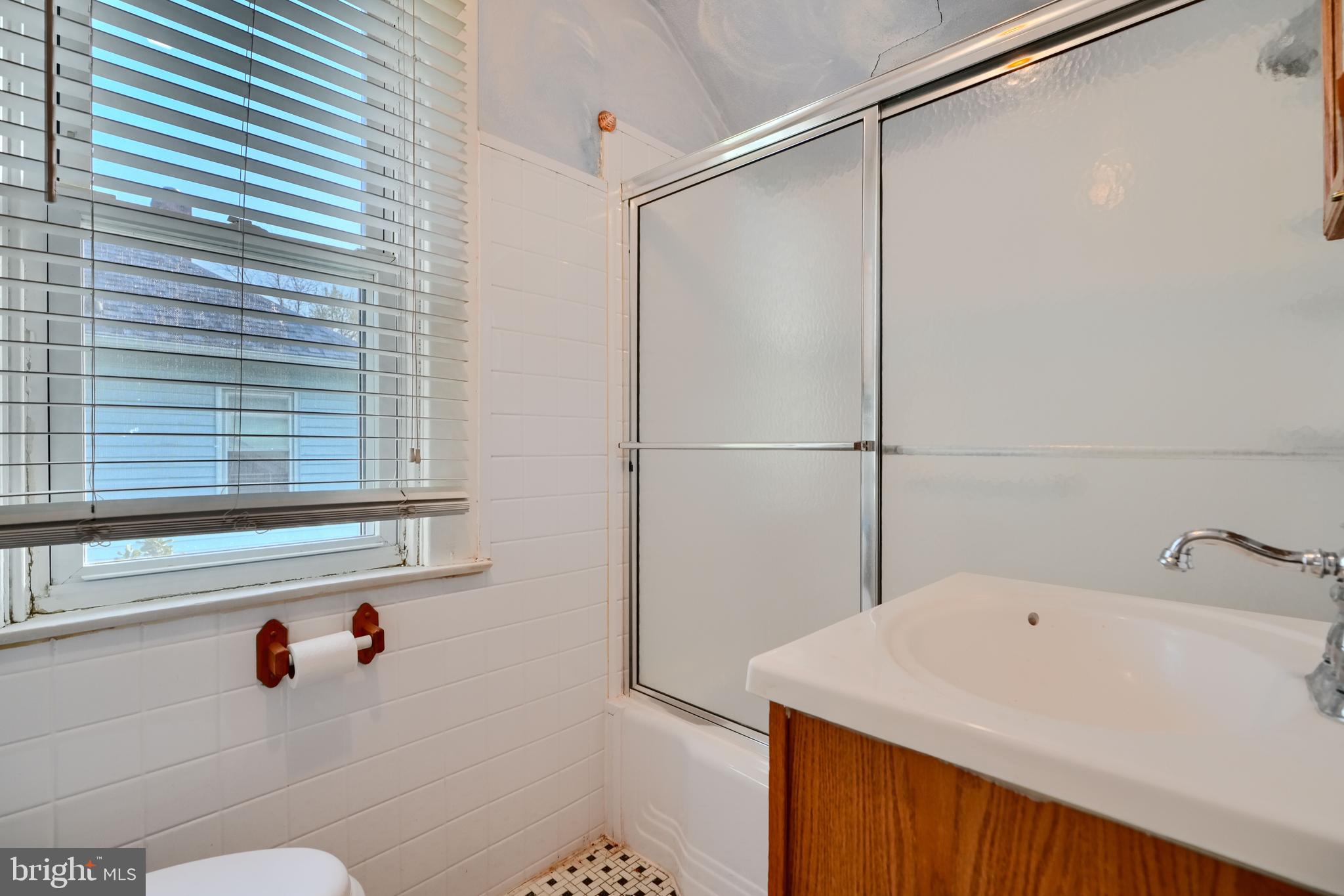 5312 Catalpha Road Baltimore, MD 21214 - Photo 27 of 37 a bathroom with a sink and a shower