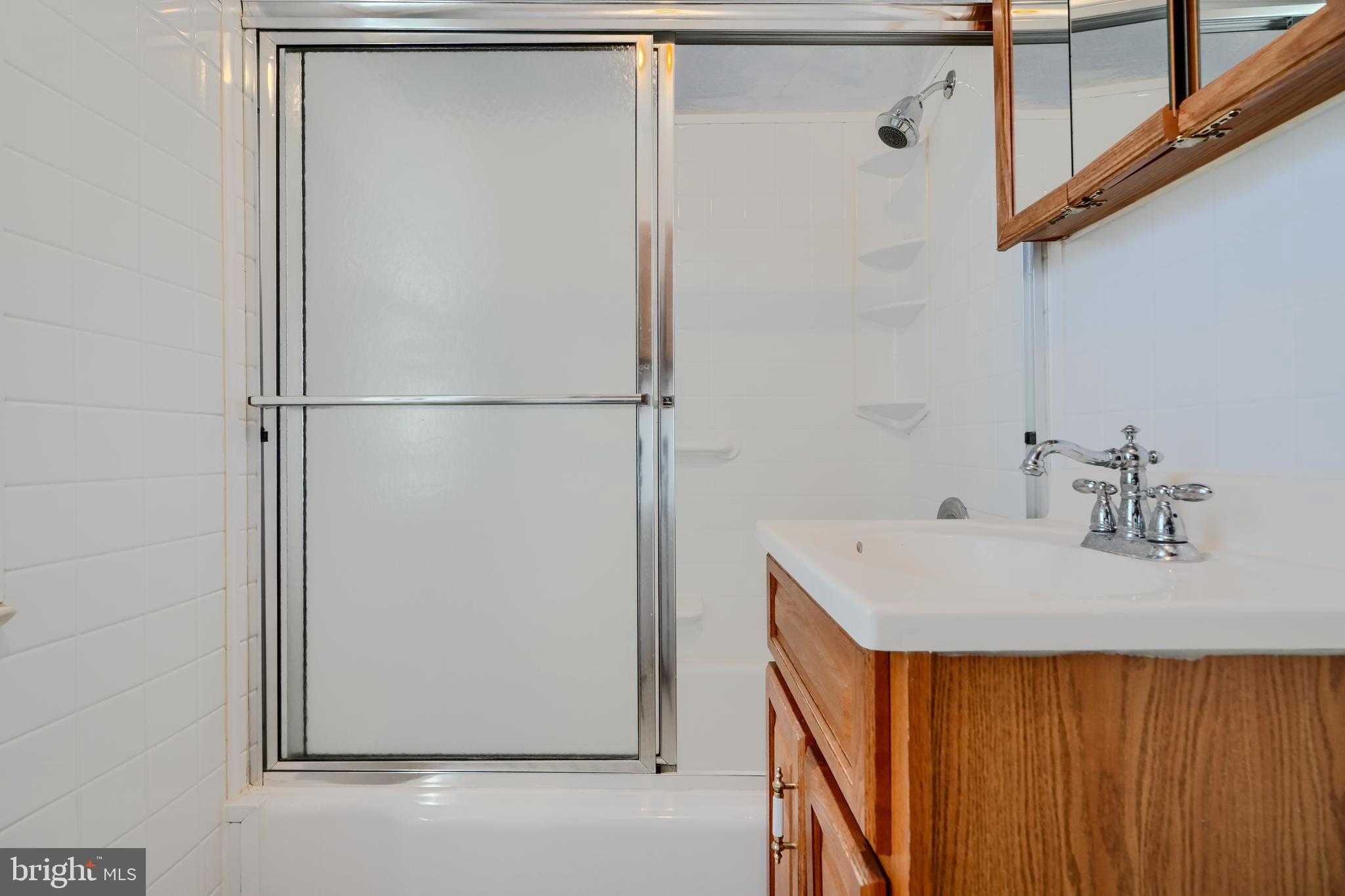 5312 Catalpha Road Baltimore, MD 21214 - Photo 28 of 37 a bathroom with a sink and mirror