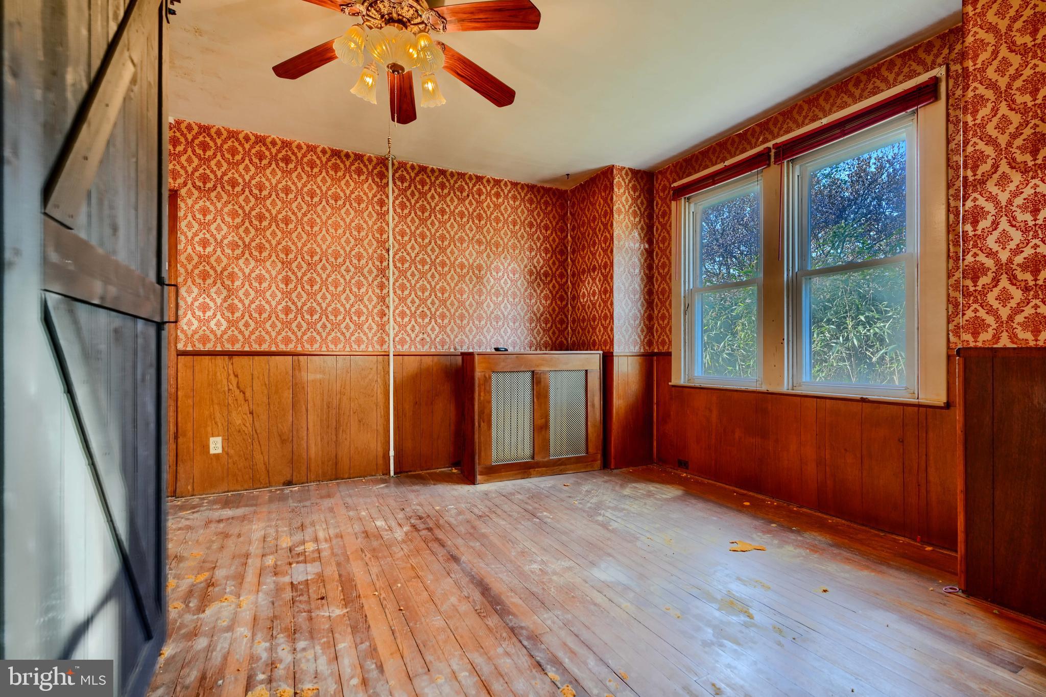 5312 Catalpha Road Baltimore, MD 21214 - Photo 8 of 37 an empty room with wooden floor and windows