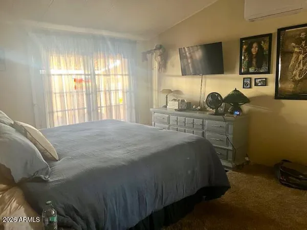 a bed sitting in a bedroom next to a window