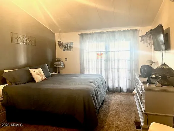 a bedroom with a bed and window