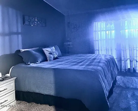 a bedroom with a bed and window