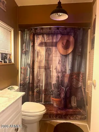 a bathroom with a toilet a sink and a mirror