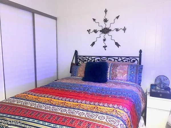 a large bed sitting in a bedroom next to a cabinet