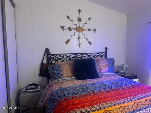 a bed sitting in a bedroom and dressers