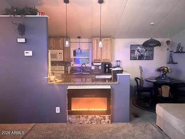 a kitchen with stainless steel appliances kitchen island granite countertop a sink cabinets and window