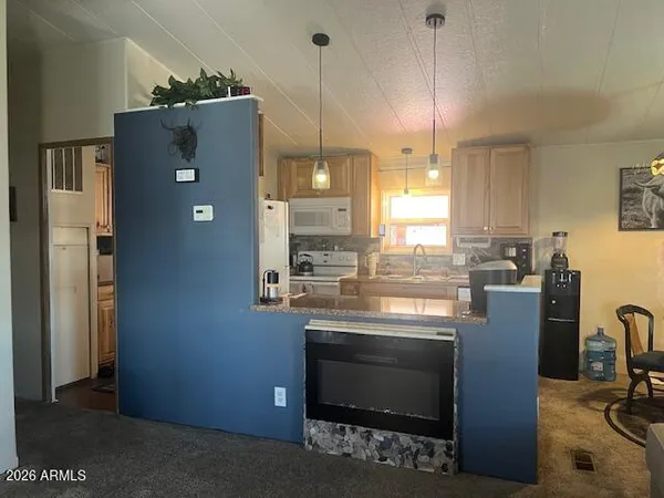 a kitchen with refrigerator and window