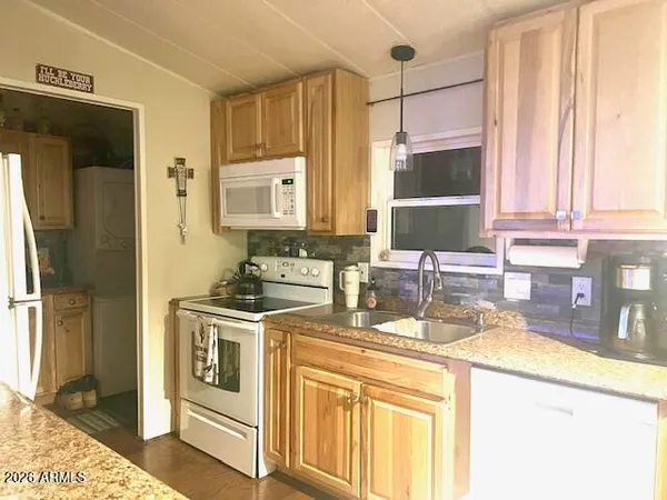 a kitchen with a sink stove and refrigerator