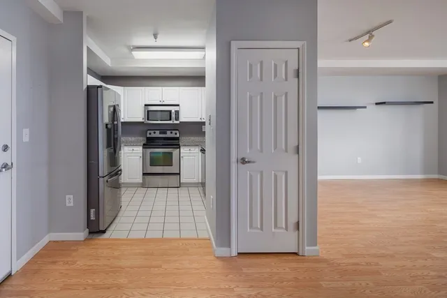 a kitchen with cabinets and stainless steel appliances