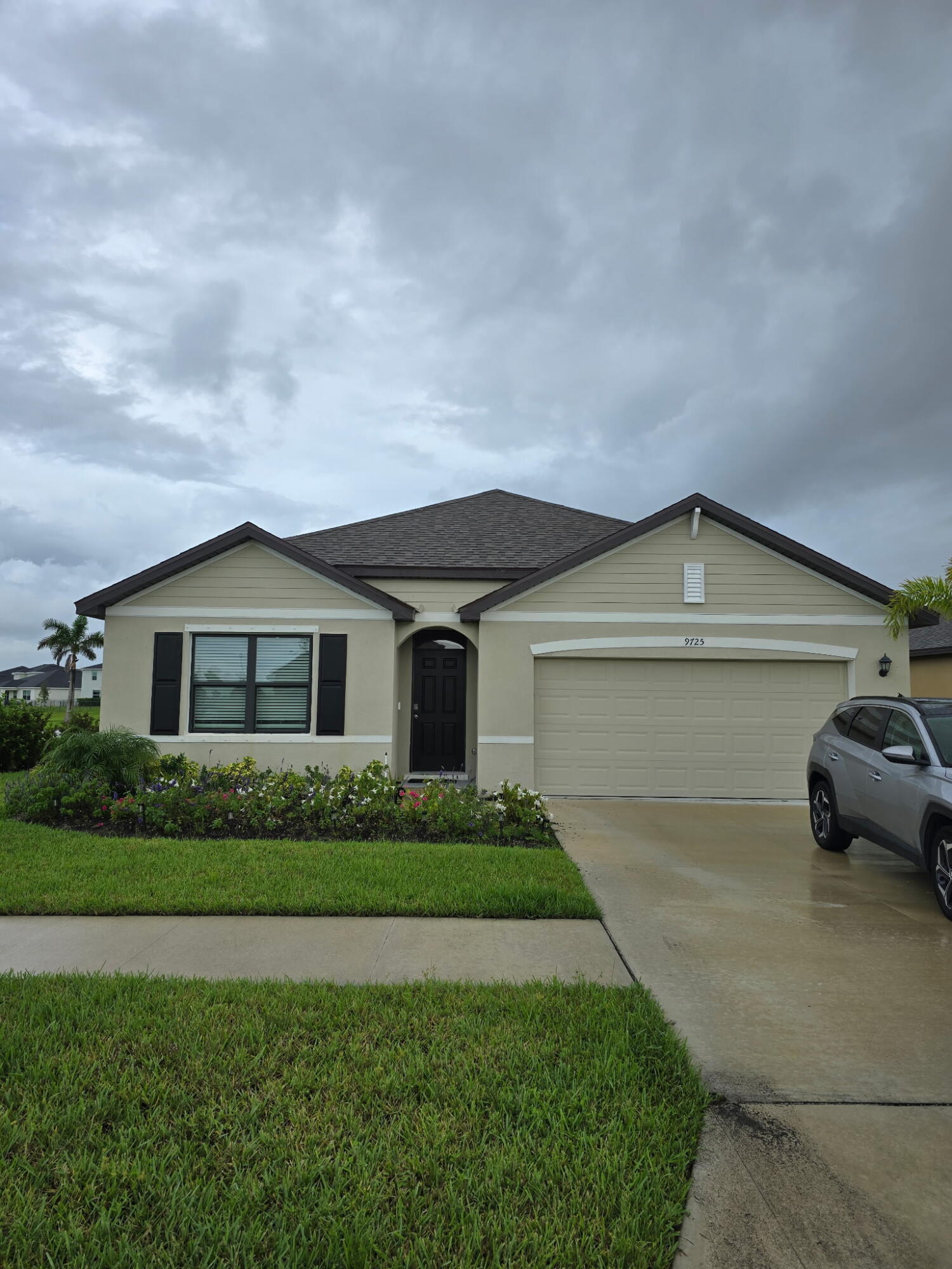 a front view of a house with a yard and garage